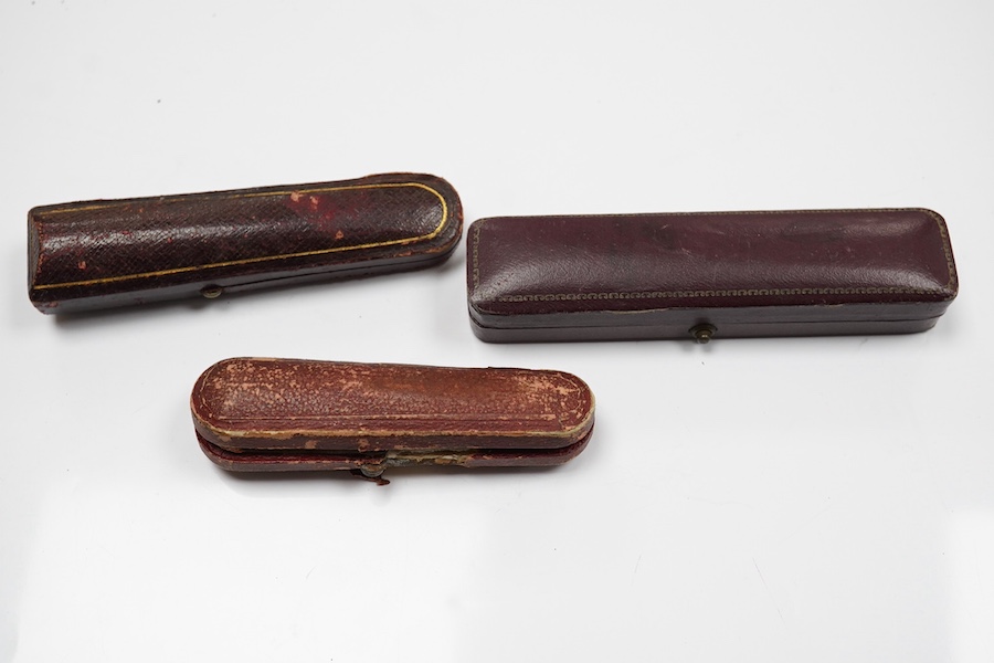 Three assorted cased cigarette holders, including amber, largest 10.1cm. Condition - fair